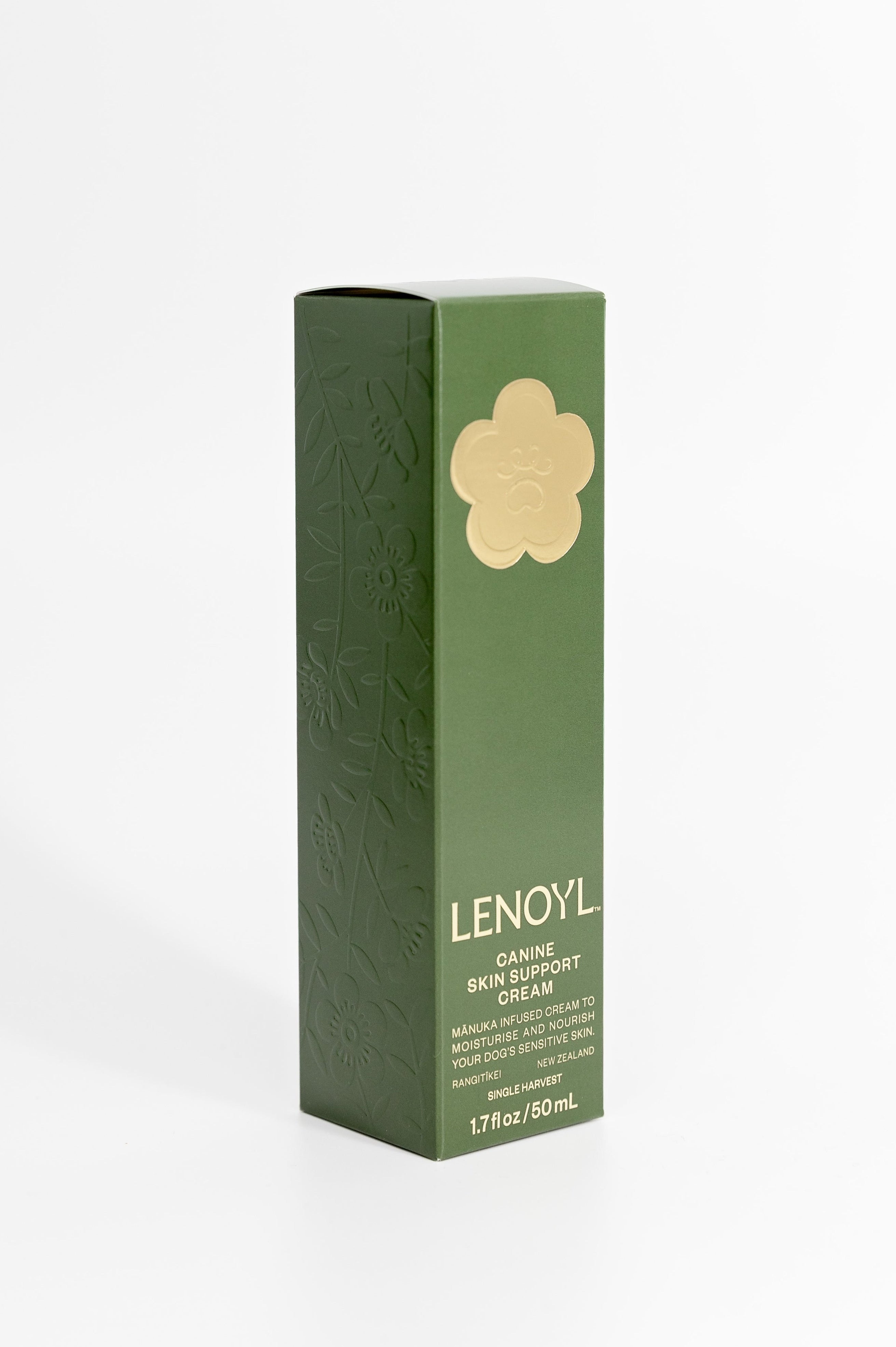 Lenoyl Canine Skin Support Cream in a tall, dark green rectangular box with a gold flower logo and embossing feature panel. Set against a plain white background.